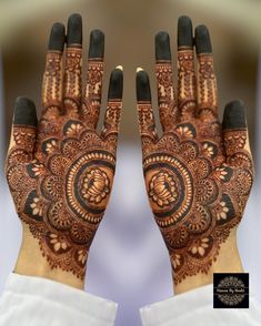 two hands with henna designs on them