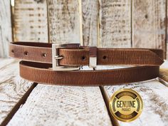 Indulge in timeless style with our meticulously crafted handmade brown narrow leather belt. Each piece is expertly finished with a vintage touch, exuding character and charm. The sleek 2cm width and elegant silver buckle add sophistication to any outfit, making it a versatile accessory for both men and women. Elevate your wardrobe with this artisanal masterpiece, designed to withstand the test of time and garner admiration wherever you go. Features: Made of high-quality genuine leather 2 cm width Unisex Available in a variety of colors Benefits: Stylish and versatile Durable and long-lasting Comfortable to wear Perfect for any occasion Guarantee: We are so confident that you will love this belt that we offer a 100% satisfaction guarantee. If you are not happy with your purchase for any rea Timeless Brown Belt Buckles For Business, Vintage Bridle Leather Belt For Everyday Use, Classic Leather Belt Buckles As Gift, Classic Leather Belt Buckles For Gifts, Classic Brown Belt Buckles For Gift, Classic Brown Belt Buckle For Gift, Classic Brown Belt Buckles As Gift, Classic Brown Belt Buckle As Gift, Classic Brown Belt Buckle Gift