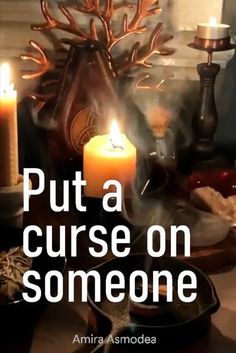 a candle that is sitting on a table with some food in front of it and the words put a curse on someone