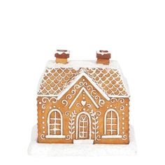 a gingerbread house is shown with icing on the roof and windows in the snow