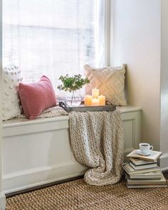 a window sill filled with books and a candle