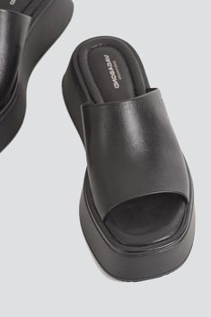 Black Courtney Slide from Vagabond Shoemakers. Minimal slip-on sandals Courtney. Wide leather strap, padded insoles and square toes. The upper sets on solid flatform outsoles. - Cow leather - Made in Vietnam - Heel height: 2" Platform Slip-on Slide Sandals, Leather Platform Slides Slip-on, Black Platform Slip-on Slides, Black Platform Slip-on Sandals, Black Non-slip Slide Platform Slippers, Vagabond Shoes, Brooklyn Candle Studio, Indie Design, Slip On Sandal