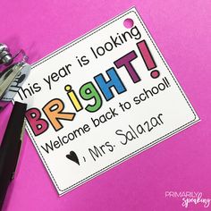 this year is looking bright welcome back to school sign with scissors on pink paper background