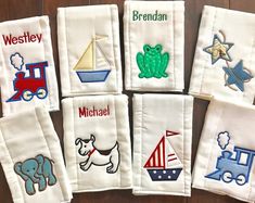 embroidered baby handkerchiefs with animals and boats on them, all in different colors or sizes