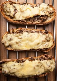 three slices of bread with cheese and mushrooms on them