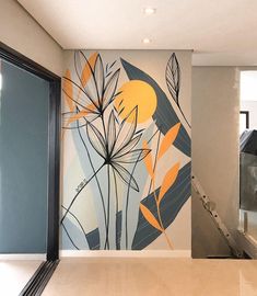 an abstract painting on the side of a wall next to a stair case and glass door