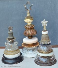 three glass vases sitting next to each other on a table