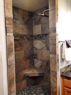 a walk in shower sitting inside of a bathroom