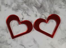 Large Laser cut Earrings. These mirror acrylic earrings are approximately 1.75 in by 2 in. They are a deep red color and complete with sterling silver fishhook closures. Super large these earrings are a conversation starter. They are romantic and would look adorable on a date, out on the town, or as everyday wear. Those who love extra large earrings, bold things, maximalists, and the like. The mirror acrylic gives a nice effect catching the light, and the top of the earrings are super glossy. Earrings Bold, Fishhook Earrings, Red Mirror, Laser Cut Earrings, Cut Earrings, Mirror Acrylic, Deep Red Color, Fish Hook Earrings, Large Earrings