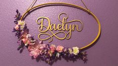 a circular sign with the word dainty hanging from it's side on a purple wall