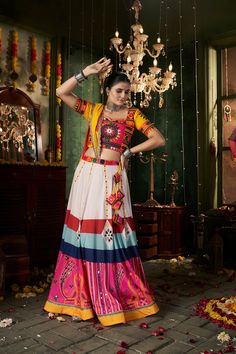 Description Add a touch of color to your wardrobe with our Multicolored Cotton Thread Mirror Worked Lehenga Choli. Perfect for any occasion, this lehenga choli is made with high quality cotton thread and features beautiful mirror work that will make you stand out from the crowd. Be the envy of all your friends with this stunning piece!Elevate Navratri with this stunning lehenga choli set. Made with Maslin Cotton fabric, it features a printed design & mirror work. The flowing flare & comfortable Navratri Collection, Sequence Blouse, Mirror Work Lehenga, Indo Western Gown, Saree Petticoat, Navratri Festival, Full Sleeve Blouse, White Peacock, Statement Outfit