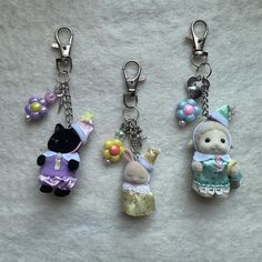 three key chains with small stuffed animals on them