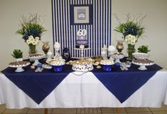 a table topped with lots of desserts next to a blue and white striped wall