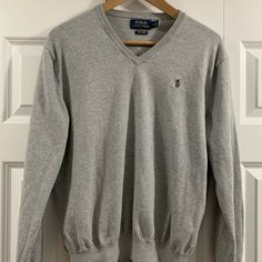 Ralph Lauren Polo Cotton V-Neck Sweater Size Medium Color Grey. Excellent Condition. Never Worn. Smoke Free - Pet Free Home Silver V-neck Top For Fall, Fall Season Silver V-neck Top, Classic Gray V-neck Top, Sweaters Ralph Lauren, Polo Ralph Lauren Sweater, Ralph Lauren Sweaters, Ralph Lauren Polo, Grey Color, V Neck Sweater