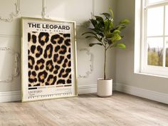 the leopard print is displayed next to a potted plant in front of a window