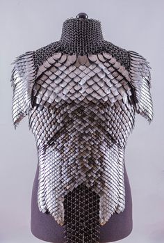 a mannequin made out of silver and black material with chains attached to it