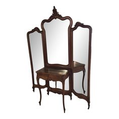 an antique wooden dressing table with mirror and stool