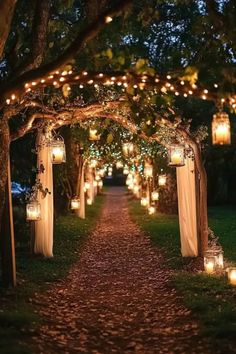 A beautifully lit rustic wedding aisle featuring hanging candles in mason jars and fairy lights along a tree-lined path for a fall garden ceremony. Tuscan Prom Theme, Unique Wedding Aisle Decor, Garden Theme Wedding Decor, Rustic Wedding Aisle, Fall Forest Wedding, Enchanted Garden Theme, Shrek Wedding, Faerie Wedding