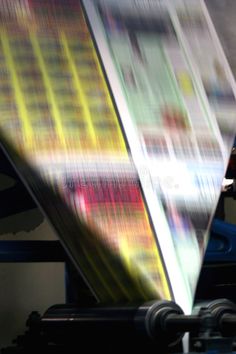 an image of a large sheet of paper being printed on a machine stock images and clippings