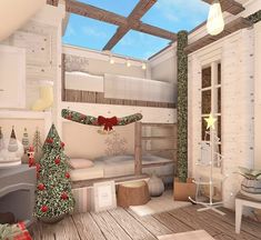 the room is decorated for christmas with white walls and wood flooring, along with a tree