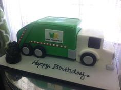 a green and white birthday cake with a garbage truck