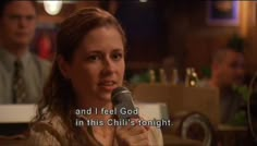 a woman holding a microphone in front of her face with the words and i feel god in this chili's tonight