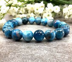 ✦Gemstone: Natural Apatite ✦Color: blue ✦Shape: Round  ✦Length: 5''-9'' ✦Bead Size: 10mm ✦QTY: 1 pc / package ✦✦Please measure your wrist size, then order the bracelet. Apatite is a stone of manifestation. It is related to service and to humanitarian pursuits. ... Apatite enhances creativity and the intellect. It clears confusion and frustration, reducing irritability and awakening the inner self. Apatite expands knowledge and truth and eases sorrow, apathy, and anger. Color may vary slightly due to your monitors' color calibration settings. Please allow 0.2-0.5mm measurement error due to different measurement manner. PLEASE feel free to contact us, if you have WHOLESALE QUERY OR ANY OTHER QUESTION Thanks for your kindly understand! Apatite Bracelet, Blue Apatite Bracelet, Chinese Bracelet, Healing Gemstone Bracelets, Reiki Jewelry, Amazonite Bracelet, Crystal Healing Bracelets, Bracelet Blue, Blue Apatite