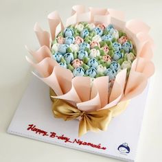 a birthday card with a bouquet of flowers on it and a ribbon tied around the top