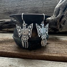 "Our artist created a very unique pair of Phoenix earrings with 3 dangling feathers on the tail. The hand stamping with small raised triangles on the wings make these super lightweight, but fabulously detailed earrings, perfect for any occasion whether it is everyday wear or a special event! They are solid sterling silver and are featured on plain shepherd hook wires. They measure 1 3/8\" long X 1\" wide.  You are not purchasing this exact piece, the stone colors will vary, so if you have a colo Bohemian Silver Jewelry With Bird Design, Silver Bohemian Jewelry With Bird Design, Sterling Silver Feather Earrings Gift, Bohemian Silver Feather Earrings, Silver Bohemian Feather Earrings, Silver Bird Design Drop Earrings, Silver Drop Earrings With Bird Design, Phoenix Earrings, Shepherds Hook