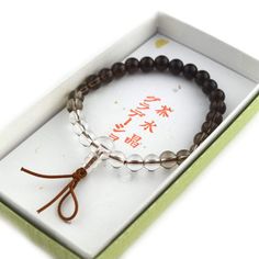 Smoky Quartz Gradation Japanese Juzu Bracelet Characteristics of the product Material : Smoky Quartz, Silk elastic cord Diameter : about 50mm We adjust the size to your wrist for a fee. Head beads : about 10mm Main beads : about 7mm Handmade in Kyoto, JAPAN About smoky quartz This greyish crystal is believed to be a symbol of strength and endurance thus helping you face difficulties and negative energies. If you've been experiencing difficulties or dealing with new challenges, smoky quartz may b Adjustable Brown Wristband With 8mm Beads, Adjustable 8mm Beads Wristband For Everyday, Everyday Adjustable 8mm Beads Wristband, Adjustable Brown Stretch Bracelet For Meditation, Adjustable Brown Crystal Bracelet With 8mm Beads, Adjustable Stretch Bracelet With 108 Beads As Gift, Kumihimo Bracelets, Symbols Of Strength, Traditional Ceramics