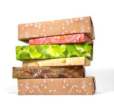 a stack of sandwiches with lettuce, tomato and cheese on them sitting next to each other