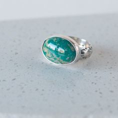 * Fox mine turquoise stones, set in sterling silver with a fine silver bezel.  * Unique East West orientation of stone * Hand stamped, sterling silver band.  * One of a kind and made by Good Wknd, by hand. *This is a gorgeous and unique stone you'll be able to enjoy for decades! DETAILS: * Metal: Sterling and fine silver * Stone: Fox mine turquoise * Size: US 6.75 * This ring cannot be resized ----------------------------------------------------------------- PACKAGING All items are boxed together, when it makes sense to do so, unless otherwise requested. I'll be happy to box your purchases separately - just let me know! Please see FAQs for additional information.  Back to the shop: https://www.etsy.com/shop/GoodWknd Oval Silver Chrysocolla Turquoise Ring, Oval Turquoise Chrysocolla Ring In Silver, Sterling Silver Rings With Turquoise Natural Stones, Artisan Oval Turquoise Ring In Sterling Silver, Fine Jewelry Sterling Silver Oval Turquoise Ring, Oval Turquoise Sterling Silver Ring With Natural Stones, Oval Turquoise Ring In Sterling Silver, Oval Turquoise Ring With Natural Stones In Sterling Silver, Oval Turquoise Gemstone Ring In Sterling Silver