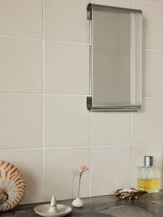 a bathroom sink with a mirror and soap dispenser on the counter top