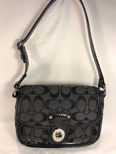 This Coach Signature Handbag Is So Cute And Will Go With Any Outfit!  Exterior: Black Signature Canvas & Black Leather Shoulder Strap & Trim Flap over easy turn key closure. Front pocket great for phone or essentials. Adjustable shoulder strap with a 7-8" strap drop. Silver tone hardware Interior: Black fabric lining. 2 slip pockets Bag Measurements: Height = 6", Width = 8", Depth = 2.5" Excellent condition for preowned. Coach Logo Charm Tag Attached! From Smoke Free Closet No Returns No guarantees on the authenticity of all our items. Check out our site for other similar listings! Black Flap Shoulder Bag With Branded Hardware, Sza Concert, Lake Ozark, Coach Logo, Bag Measurements, Signature Canvas, Pocket Bag, Concert Outfit, Black Fabric