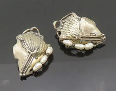 "925 Silver - Vintage Baroque Pearls Modernist Non Pierce Earrings - EG10390  925 Silver - Vintage Baroque Pearls Modernist Non Pierce Earrings - EG10390  Jewelry Type:         Earrings   Metal Type:            925 Silver   Metal Size:             1.5\"  Stone Type:            Pearls   Condition:              N/A  Jewelry Weight:     24.7 Grams  PLEASE NOTE: THIS ITEM IS PRE-OWNED. ALTHOUGH MOST ITEMS ARE IN VERY GOOD CONDITION, SOME MAY NEED CLEANING AND/OR MINOR REPAIRS. WE MAKE A VERY STRONG EFFORT TO UPLOAD CLEAR PICTURES. PLEASE INSPECT ALL PICTURES AND ASK ALL QUESTIONS YOU MAY HAVE PRIOR TO MAKING A PURCHASE. NOT ALL STONES ARE GENUINE, SOME ARE ENHANCED OR CREATED." Silver Victorian Pearl Earrings For Anniversary, Victorian Silver Pearl Earrings For Anniversary, Antique Silver Pearl Earrings For Anniversary, Ornate Silver Pearl Earrings, Silver Baroque Pearl Earrings For Formal Occasions, Silver Baroque Pearl Earrings For Formal Events, Baroque Pearl Earrings In Silver For Formal Occasions, Baroque Pearl Earrings In Silver For Formal Events, Unique Silver Pearl Earrings For Wedding