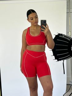 Made for a hike or for under your favorite oversized sweatshirt, the Christopher Contour Shorts feature contoured piping details and a high waisted fit. Wear alone or as a set with any of our Charcoal grey sports bras and tanks. Mid thigh length Thin, white contouring piping Ruby red coloring Double layered high waist Inseam length on size S: 5" Made of our VERSA fabric: smooth, buttery, and form fitting 85% polyamide, 15% spandex Your order will ship from our warehouse in FL, USA! Cute Workout Outfits, Gray Sports Bra, Cozy Outfit, Red Outfit, Sporty Outfits, Athletic Outfits, Airport Outfit, Oversized Sweatshirt, Waist Pants