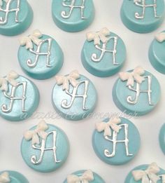 blue and white decorated cookies with monograms on them