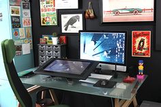 a glass desk topped with a computer monitor