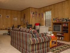 a living room filled with furniture and a flat screen tv