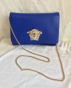 Formal Blue Bag With Chain Strap, Formal Blue Shoulder Bag With Chain Strap, Blue Clutch Bag With Chain Strap, Blue Clutch Shoulder Bag With Chain Strap, Blue Formal Clutch With Chain Strap, Elegant Blue Bag With Chain Detail, Blue Clutch With Chain Strap For Formal Occasions, Blue Shoulder Bag With Chain Strap For Shopping, Blue Clutch With Chain Strap For Formal Events