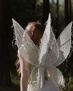 a woman dressed as a fairy with white wings