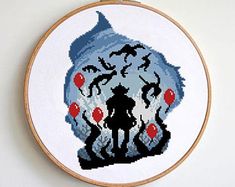 a cross stitch pattern with an image of a woman in a blue dress and red balloons