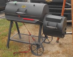 a bbq grill sitting on top of a metal cart