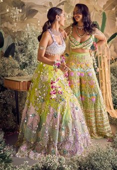 Unveil the magic: lime to lilac bridal lehenga set. Ombre perfection adorned with glass cut beads, crystal stones, pearls, and floral appliqués. Paired with a glamorous tube blouse embellished with metals, sequins, and pearls. Complete the look with an asymmetrical pre-stitched dupatta for a touch of grace and allure. Experience the enchantment on your special day! Colorful Indian Outfit, Pretty Indian Outfits, Green Outfit Indian, Lehenga Designs Green, Mehendi Lehenga Brides, Mehndi Outfit Bridal Indian, Mehendi Dresses For Bride, Lehenga New Design, Bridal Haldi Outfit Indian