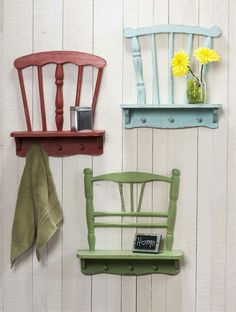 two wooden chairs and a shelf with flowers on it