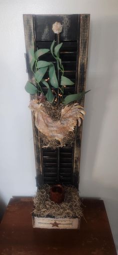 a plant in a wooden vase on top of a table