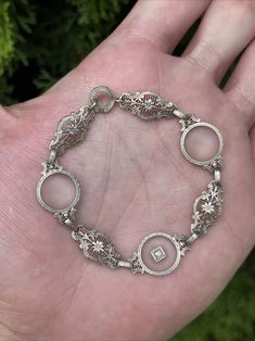 For sale is the beautiful Art Deco 14k White Gold Filigree Bracelet. It measures 7” and weighs 9.1 grams. It has 3 pieces of camphor glass and a small diamond. It’s in excellent condition. It’s been X-ray tested at 14k. Please contact me with questions. Camphor Glass Jewelry, Gold Filigree Bracelet, Vintage Gold Bracelet, Bracelet White Gold, Filigree Bracelet, Gold Filigree, Art Deco Era, Vintage Bracelets, X Ray