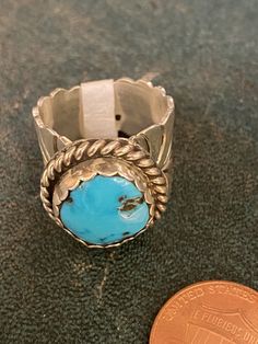 Our Outlaw Ring Collection features genuine stones, and sterling silver. Each ring is handcrafted by Navajo artisans. They are all one-of-a-kind. Pick the number of your favorite and check the description for sizing information. 1: Size 8: Turquoise and coral ring with ornate silver work. Stamped Sterling, HBY. 2: Size 6.5: Sterling feather ring measures 2" long. Stamped sterling, C.C. 3: Size 7.25: Massive 1.25 x .75" turquoise stone with ornate feather and flower details. Stamped Peterson John Classic Handmade Turquoise Ring For Anniversary, Artisan Turquoise Ring Round Collectible, Artisan Round Turquoise Ring Collectible, Untreated Round Turquoise Collectible Ring, Artisan Round Turquoise Collectible Ring, Classic Adjustable Turquoise Ring, Untreated Turquoise Ring, Artisan Turquoise Round Ring For Anniversary, Classic Collectible Round Turquoise Ring