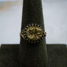 This large authentic human tooth is dipped in antique gold gild and set to rest in a antique gold plated 925 sterling silver adjustable bezel ring setting