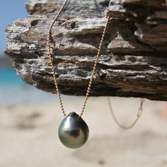 Simplicity and elegance for this made to order necklace featuring huge and rare 13 mm Tahitian black or silver half-baroque / cirlced pearl mounted on a very thin 14k gold filled ball-chain. The Tahitian pearl of this size are rare and the one you will receive will have a great luster (Mirror effect) of a C+ quality which i carefully drilled drop style. Super natural, feminine it's a classic revisited, a real easy chic jewelry piece from St Barts. The lenght of the necklace is available in : 16 Tahiti Beach, Beach Jewelry Boho, Beautiful Pearl Necklace, Black Pearls, Tahitian Black Pearls, St Barts, Jewelry Boho, Tahitian Pearls, Chic Jewelry